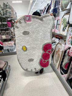 a hello kitty pillow is on display in a store