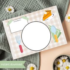 a table with flowers and place cards on it next to a bowl of daisies