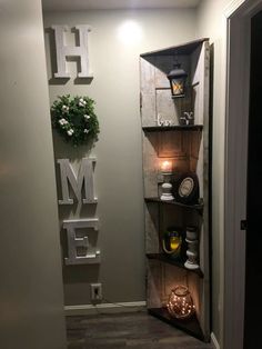 an open door leading into a room with shelves on the wall and candles in it