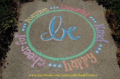 a sidewalk with the words be happy written in chalk and colored pencils on it