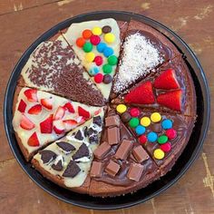 a chocolate cake topped with lots of different types of candy and candies on top of it