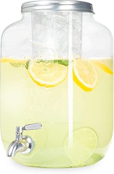 a glass pitcher filled with lemonade and ice