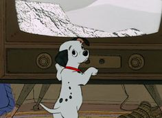 a cartoon dog standing in front of a television