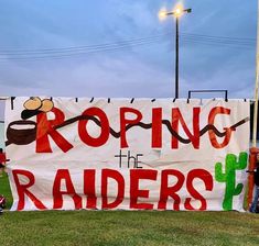 a group of people standing next to a banner