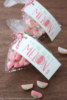 two bags filled with marshmallows sitting on top of a wooden table next to each other