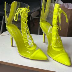 Unworn Neon Clear Heel Booties Trendy Yellow Lace-up Heels, Yellow Lace-up Party Heels, Neon High Heels For Party, Neon Yellow Party Heels In Synthetic Material, Casual Neon Yellow Synthetic Heels, Yellow Patent Leather Party Heels, Neon Yellow Pointed Toe Heels For Party, Neon Yellow Party Heels, Yellow Ankle-high Heels For Party