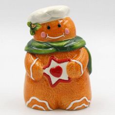 a ceramic figurine with a chef's hat and scarf on