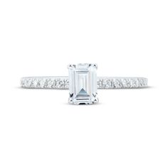 an emerald cut diamond ring with channeled shoulders