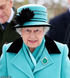 an older woman wearing a blue coat and hat