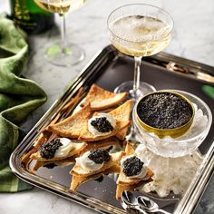 an assortment of appetizers and wine on a tray