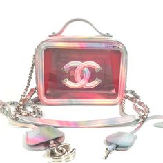 This Is An Extremely Rare Authentic Chanel Pvc Patent Lambskin Small Cc Vanity Case In Pink Multicolor. This Chic Stylish Crossbody Bag Is Crafted Of Delightful Multicolor Patent Leather With Pink Tinted Transparent Panels. It Features A Top Handle, Patent Leather Threaded Chain Link Shoulder Straps With Matching Patent Leather Shoulder Pad, And A Large Chanel Cc Stitched Logo With Silver Tips On The Front. Base Length: 6.50 In Height: 5.00 In Width: 3.25 In Drop: 1.00 In Drop: 23.7 Condition: Good Condition. Minor Signs Of Wear Present, Scratches, Scuffs, Color Transfer, Pen Marks. Please Refer To All Photos As They Are Part Of The Description. We Ship Daily 100% Positive Feedb Luxury Portable Box Bag For Shopping, Luxury Crossbody Box Bag, Luxury Portable Crossbody Box Bag, Luxury Portable Top Handle Box Bag, Luxury Portable Box Bag With Top Handle, Designer Compact Pink Bag, Luxury Multicolor Box Bag With Detachable Handle, Luxury Pink Pouch Box Bag, Designer Pink Box Bag