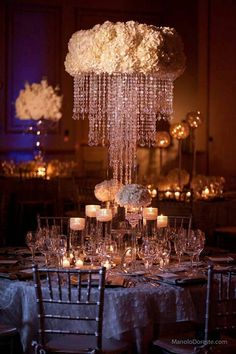 the centerpiece is made out of crystal beads and white hydranges with candles