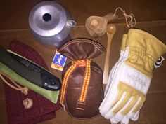 an assortment of kitchen utensils and cooking gloves