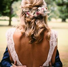 the back of a woman's head with flowers in her hair and an instagram