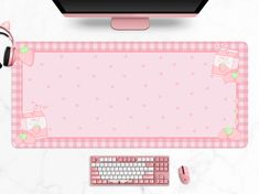 a computer keyboard, mouse and headphones sitting on a desk with a pink background