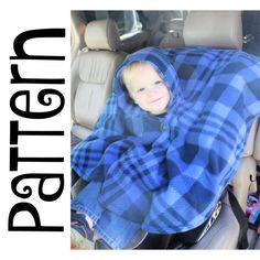 a young boy wrapped in a blue plaid blanket sitting in the back seat of a car