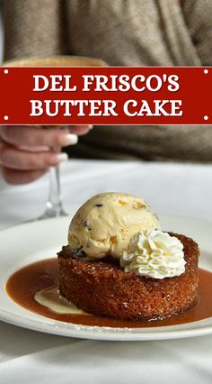 a person holding a wine glass in front of a dessert on a plate with the words del frisco's butter cake