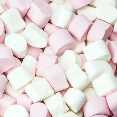 pink and white marshmallows are scattered together