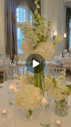 flowers and candles are arranged in vases on a table at a wedding reception for guests