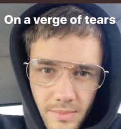 a man wearing glasses and a hoodie with the words on a venge of tears