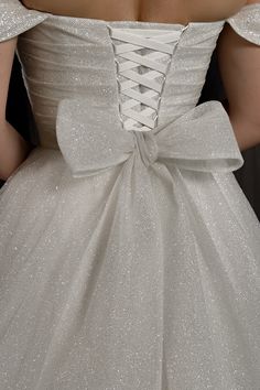 the back of a woman's wedding dress with a large bow