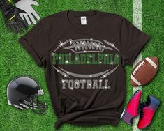 Philadelphia Rhinestone Football Shirt, Unique Design Ideal Gift Tee for Game Day, Quality and Durable Chic T-shirt, Trendy Sport Fan Shirt: Elevate your game-day style with our exclusive football-inspired shirt collection. Crafted for true fans, these tees combine comfort with bold, eye-catching designs. Show off your team pride with every wear, whether you're at the stadium or watching from home. Made from premium materials, our shirts ensure durability without compromising on style. Upgrade your fan gear today with a tee that speaks volumes about your passion for the game! Here's why you'll love it: Soft and comfy cotton fabric High-quality fabric and durable printing Made from soft and comfortable fabric. Long-lasting and vibrant prints that won't fade. Printing is high quality and dur Rhinestone Football, Sunday Fashion, Glitter Tee, Glitter Shirt, Chic Shirts, Football Lovers, Football Tees, Game Day Shirts, Fan Shirts