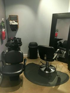 a hair salon with black chairs and mirrors