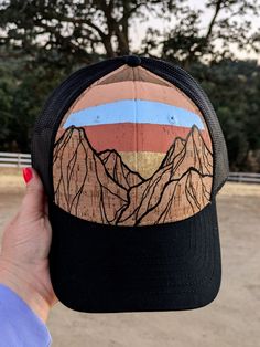 One-of-a-kind Hand Painted Hat Top Quality OTTO brand cork hat, Adjustable and comfortable, One size fits most (This is a structured style hat, not floppy or flimsy) My line of hand painted hats is inspired by the natural beauty God created in the mountains, beach, desert, and other places I like to wander. I freehand paint these designs directly on the hat. Because of this, no two hats will ever be exactly the same. Please see my other hat designs in my shop. These are painted using high qualitly acrylics, and then topped with a matte sealer for protection. These will stand up to normal use, but please do not submerge in water. Everything at TheLeatherKnot is handmade by me, with Love! Fast and free shipping on every order! Travel Baseball Cap, One Size Fits Most, Brimmed, One Size Fits Most Brimmed Baseball Cap For Travel, Adjustable Brown Hat For Hiking, Outdoor Hats With Curved Brim, Country Style Snapback Hat With Curved Brim, Travel Snapback Hat One Size Fits Most, Black Rustic Adjustable Hat, Adjustable Brimmed Baseball Cap For Outdoor Activities, Adjustable Brimmed Trucker Snapback Hat