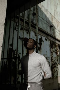 a man standing in front of an old building