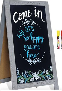 a chalkboard with some writing on it next to crayons and marker pens