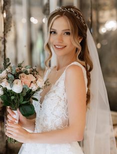 a woman in a wedding dress holding a bouquet