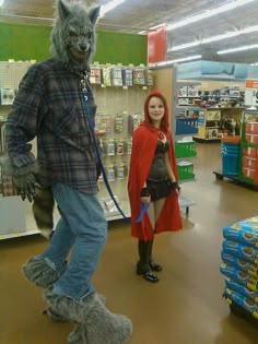 a person in a wolf costume standing next to a woman