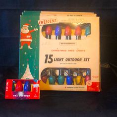 an assortment of christmas lights in boxes on a black background