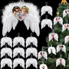 white angel wings hanging from a christmas tree next to other ornaments and decorations on a black background