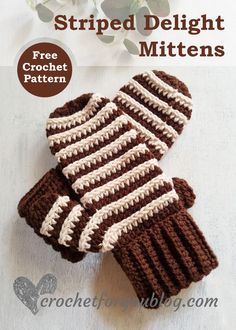 two brown and white crocheted mittens sitting on top of a table