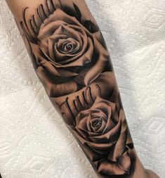 a black and white rose tattoo on the arm with words written in cursive writing