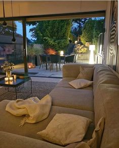 a living room filled with furniture next to a sliding glass door