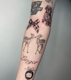 a person with a tattoo on their arm that has pictures of animals and words in it