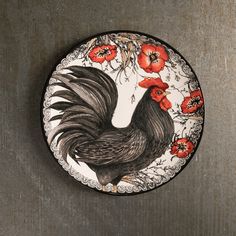 a plate with a rooster painted on it