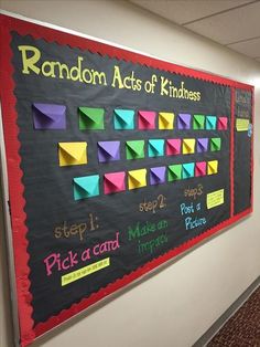 a bulletin board with sticky notes on it in an office hallway that says random acts of kindness