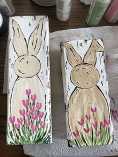 two painted wooden blocks with rabbits on them