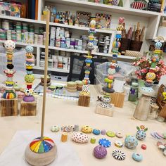 a table topped with lots of different types of buttons and vases on top of it