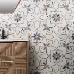 a bathroom with a wooden cabinet and floral wallpaper