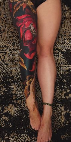 a woman with tattoos on her legs and leggings