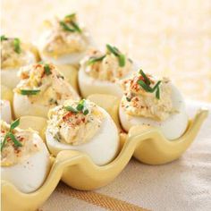 several deviled eggs are arranged on a yellow tray