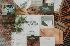 an assortment of business cards and brochures laid out on a woven tablecloth