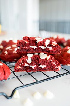 red velvet cookies with white frosting on a cooling rack, ready to be eaten