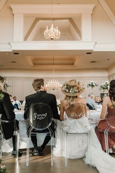 the bride and groom are sitting at their wedding reception