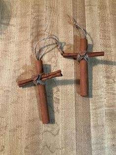 two wooden crosses are tied up on the floor