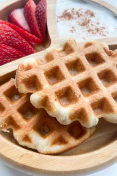 waffles and strawberries on a wooden plate